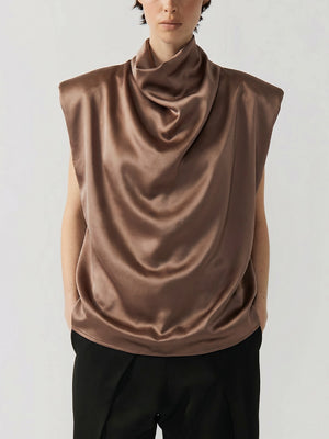 #khaki Person wearing a brown sleeveless top with a draped design on a white background