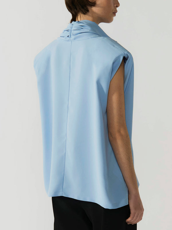 #sky-blue Light blue sleeveless top worn by a person on a plain background