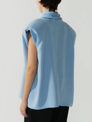 #sky-blue Person wearing a light blue sleeveless top against a plain background