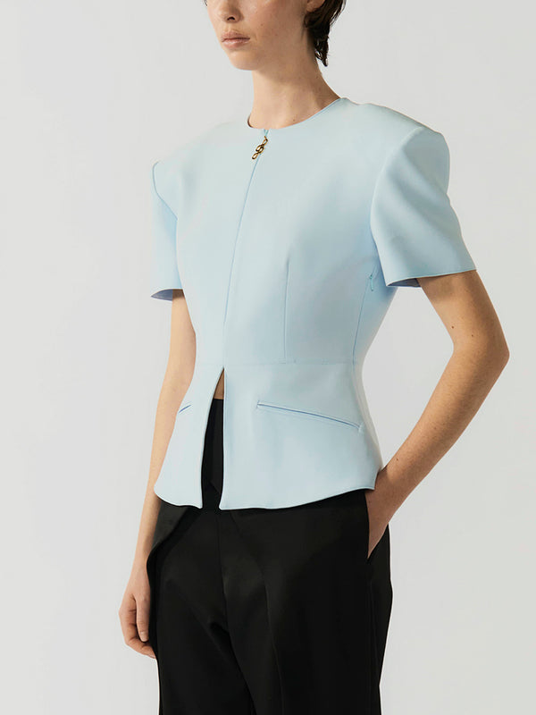 #sky-blue Light blue short-sleeve top worn by a person on a plain background