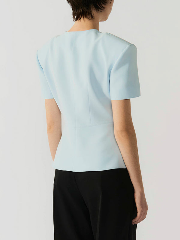#sky-blue Light blue top worn by a person on a white background