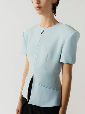 #sky-blue Light blue short-sleeve top worn by a person on a plain background