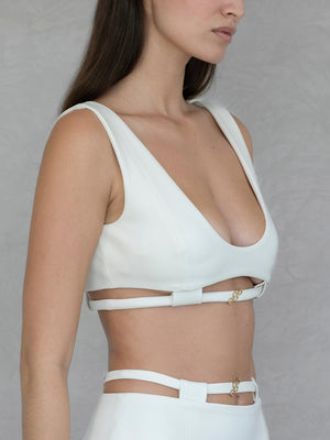 #off-white White crop top with cut-out design on a plain background