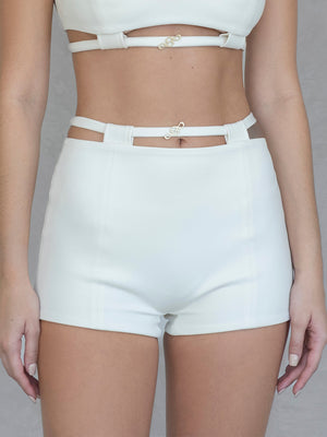 #off-white Person wearing a white outfit with a crop top and shorts on a plain background