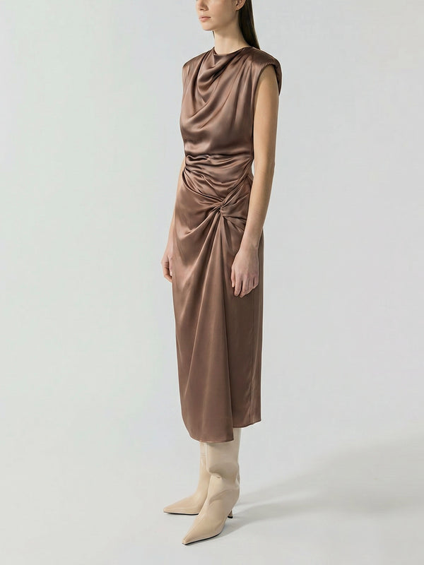 #khaki Woman wearing a brown sleeveless dress with a draped design on a white background