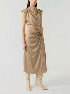 #sand Woman wearing a beige sleeveless dress with a draped design on a white background