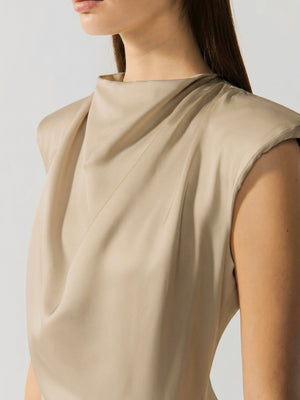 #sand Beige sleeveless top worn by a person on a light gray background
