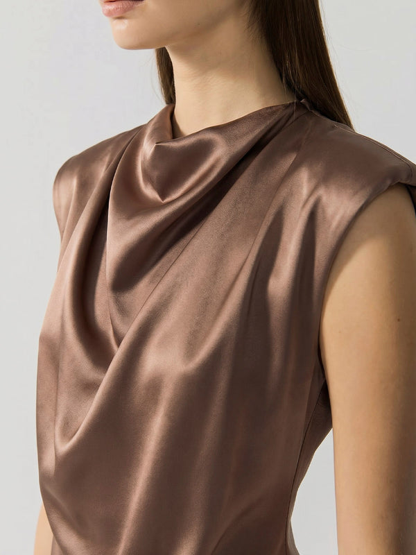 #khaki Khaki top worn by a model on a plain background