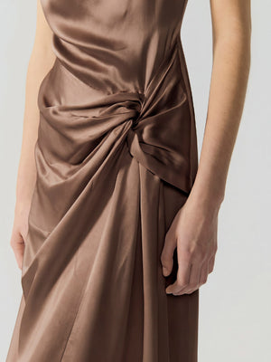 #khaki Khaki dress with a knot detail on a plain background
