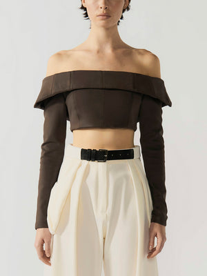 #coffee Person wearing a brown off-shoulder top and white pants on a plain background