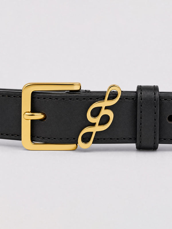 #black A close-up of a black leather belt featuring a polished gold-tone metal buckle and a matching gold infinity symbol charm on the strap, set against a light gray background.
